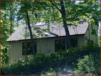 View of dwelling, looking up from main docks, howing premium thatched-look shingles & triple low-e-squared skylight.