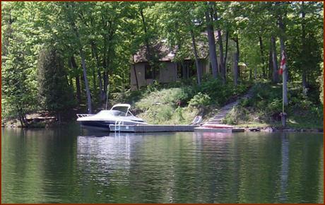 Private, sheltered bay with excellent water for swimming, kayaking, fishing... Fabulous docks for entertaining with room for several large and small craft, hundreds of feet of private naturalized shoreline, and a dwelling setback (grandfathered) which allows for excellent lake views from your living room and your expansive deck...