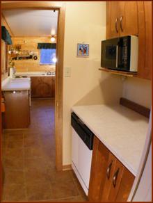 Separate "Butler's Pantry" adjacent to kitchen features food preparation station, wet-bar, built-in dishwasher, microwave and freezer and additional cabinets,  enhances functionality of the kitchen for dining and entertaining