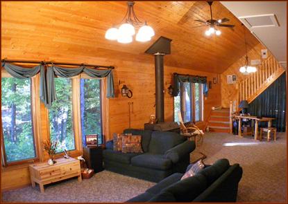 Great Room, living room, looking towards studio. Seven floor-to-ceiloing windows overlook the lake.