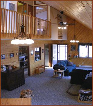 Great Room looking up to Loft, Master bedroom etc and back to kitchen (lower left) and entrance from main decks on far wall. 